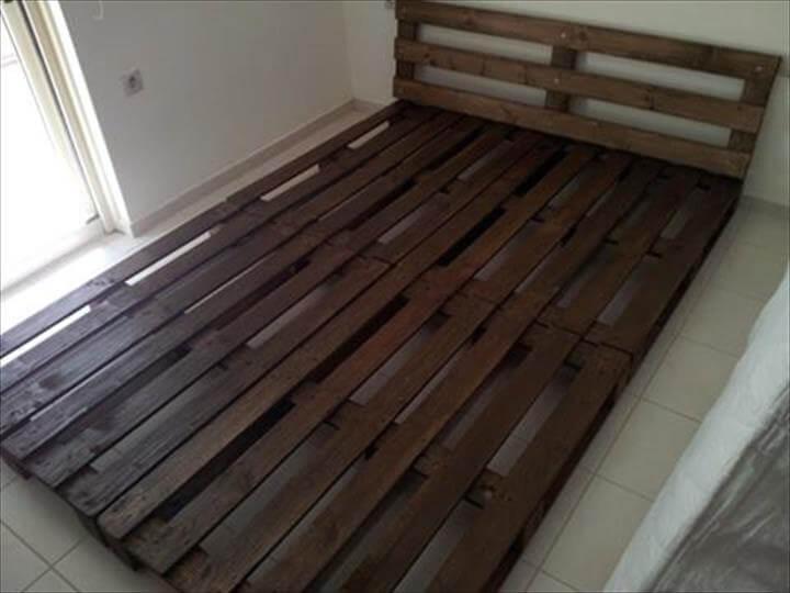 repurposed rustic pallet platform bed with headboard