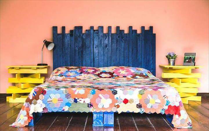 pallet platform bed with blue headboard