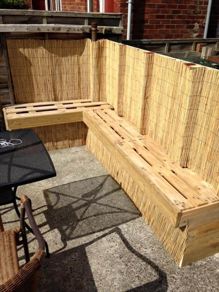 handcrafted pallet and reed fence sitting unit