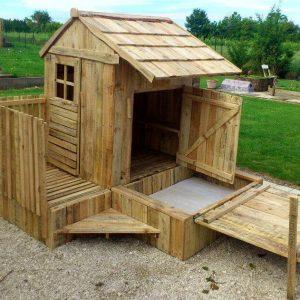 budget-friendly pallet playhouse with installed sandbox