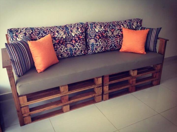 cushioned sofa out of stacked pallets