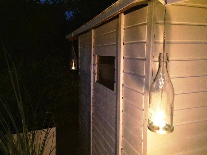 pallet wood shed with glass bottle hanging lamp