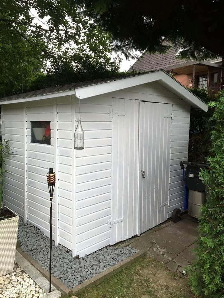 white painted pallet shed