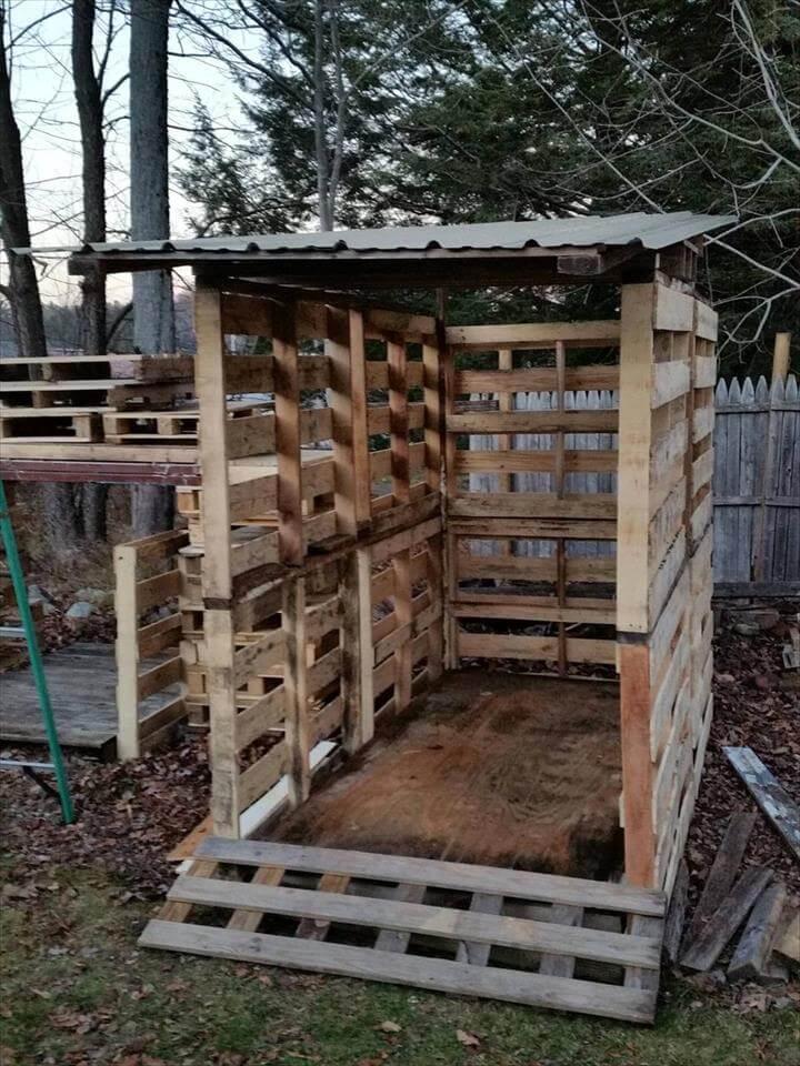 hand-built wooden pallet bike shed with metal roof