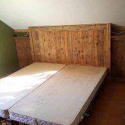 DIY Robust wooden pallet bed with headboard and white foam mattress